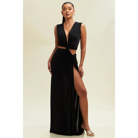 Woman wearing a black evening gown with a deep neckline and high
